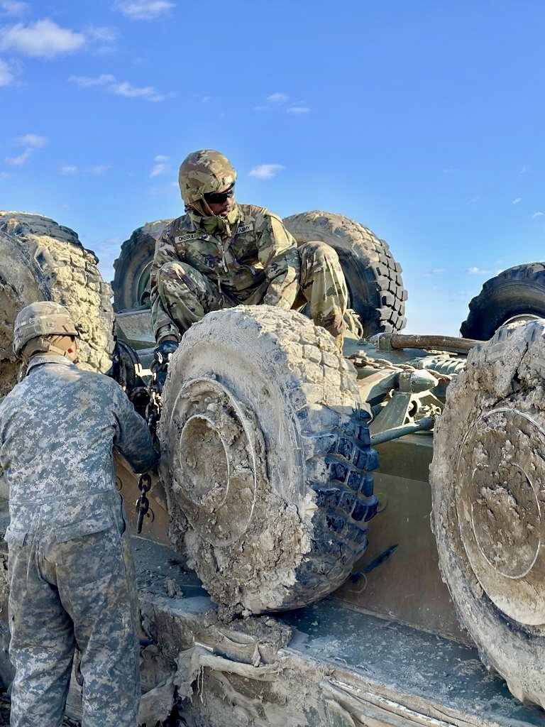 Jonah Okebulu in U.S. Army combat uniform seated on a wheeled vehicle during a recovery operation.